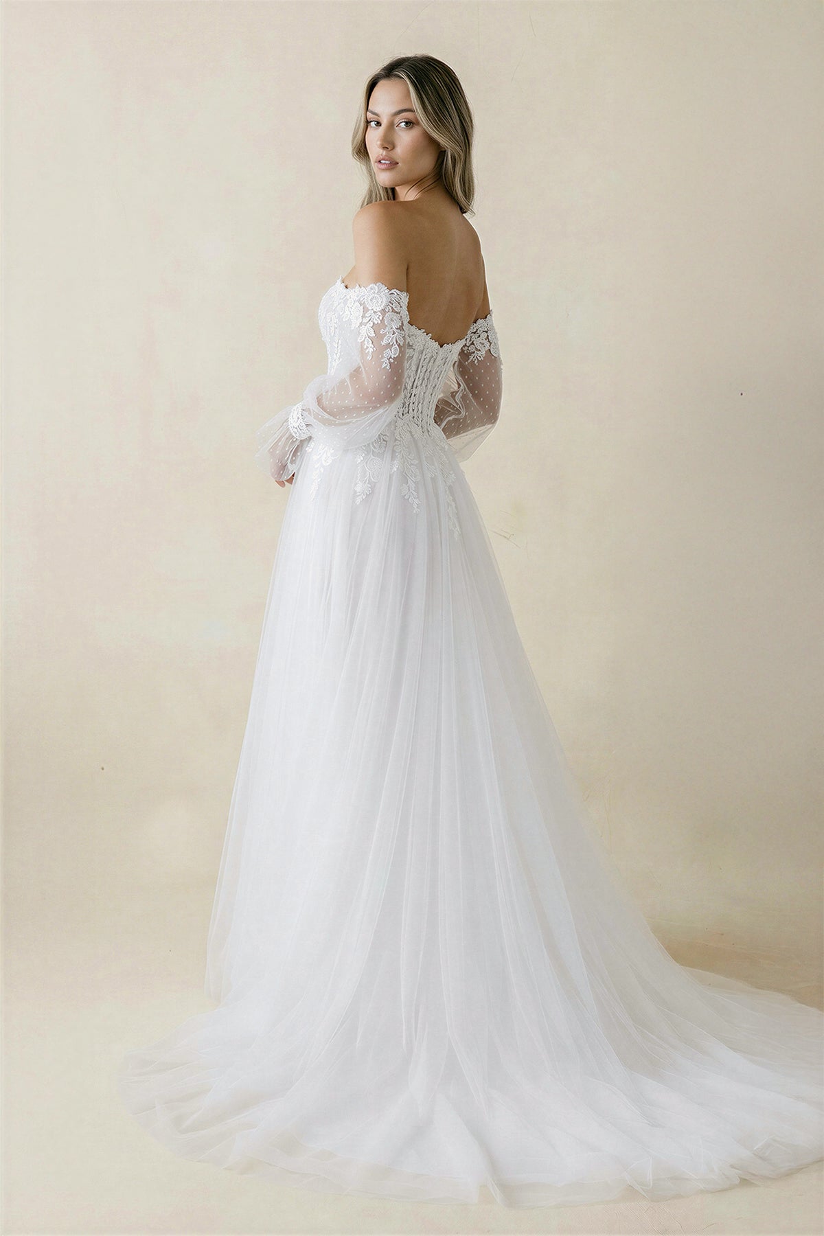 White SHEISME sweetheart A-line wedding dress with long sleeves and tulle fabric, styled for an elegant bridal look.